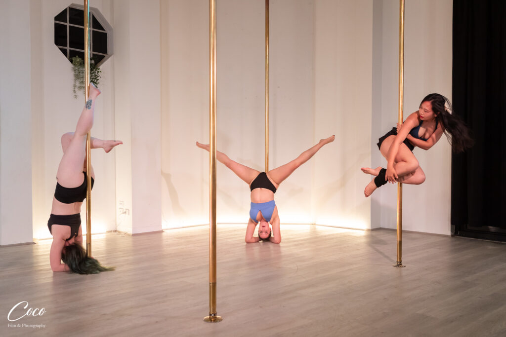 Smiling students chatting between moves at Achieve Pole Studio in Rosebery, Sydney
